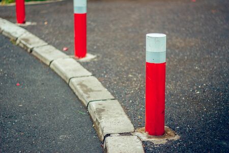 Sidewalk small red columns that prohibit automobile access. の写真素材