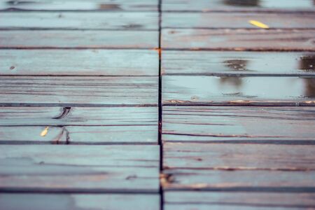 Dark wet wood planks on a rainny day baclground