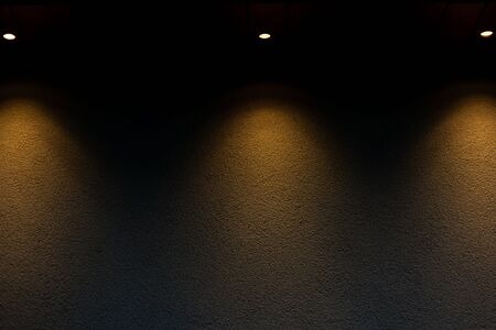 Abstract background of three LED spot lights illuminating the exterior wall of a building â€“...