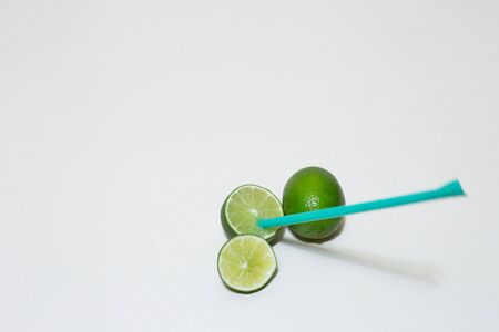 Concept of a drink with a straw in a lime â Detox drink on a white backgroundの写真素材
