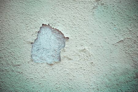 White old cracked wall plaster with rough surface -  Weathered vintage building facadeの写真素材