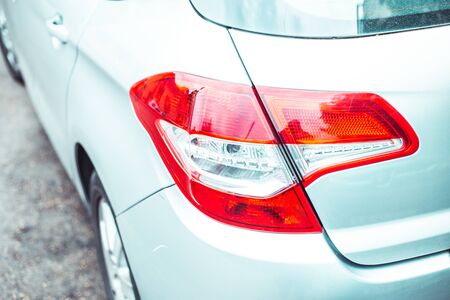 Rear lights of a modern European car - Red braking lamps of a parked vehicleの写真素材