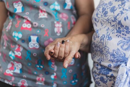 Nurse helping senior woman in the hospital - Female doctor offering medical support to old lady in a private clinic - Medical assistant taking care of elderly personの写真素材