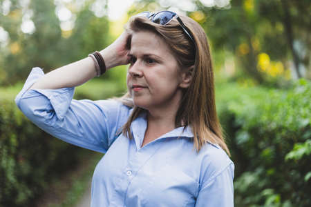 Business woman thinking and scratching head - Office lady planning her next move with sunglasses...