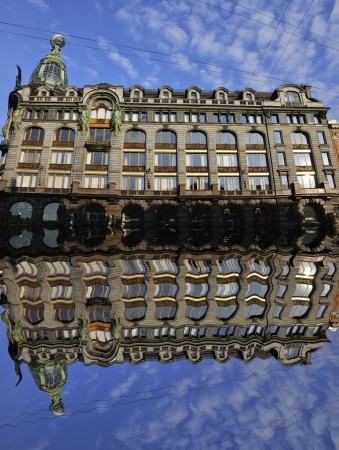 Old building of Zinger Company with reflexion in canal in Saint Petersburg, Russia with blue sky at the backgroundのeditorial素材