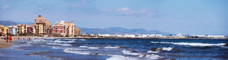 VALENCIA, SPAIN - SEPTEMBER 20: View of the early autumn beach on September 20, 2013 in Valencia, Spain. People are swimming, walking along the coast, sunbathing.のeditorial素材