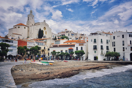 CADAQUES, SPAIN - JUNE 9, 2013: Beach of a small town on the Costa Brava of the Mediterranean, where Salvador Dali had a house. One of the main sites of the city - Church of St. Mary (17th century)のeditorial素材