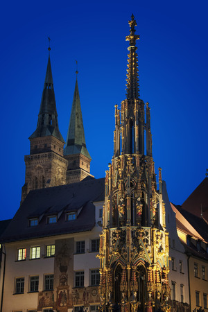 Schoner Brunnen - Beautiful Fountain - at night. It is located at the main market square of Nuremberg, Germanyの写真素材