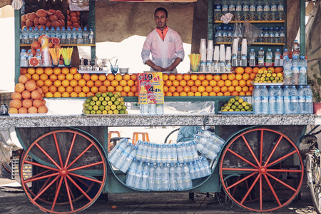 MARRAKESH, MOROCCO - MAY 25, 2014: Orange juice stall at Jemaa el Fna square in Medina with moroccan seller. It is very typical for the daytime to find many juice stall in the city centerのeditorial素材