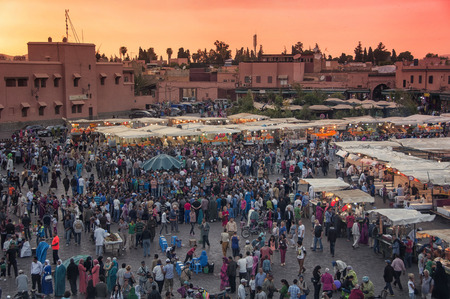 MARRAKESH, MOROCCO - MAY 25, 2014: Sunset over Jamaa el Fna (also Jemaa el-Fnaa, Djema el-Fna or Djemaa el-Fnaa) square and market place in medina quarter. During the night it´s full of food-stallsのeditorial素材