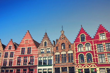 Famous old colorful buildings at Market square in Bruges, Belgium. Popular Flemish city with almost intact medieval architecture.のeditorial素材