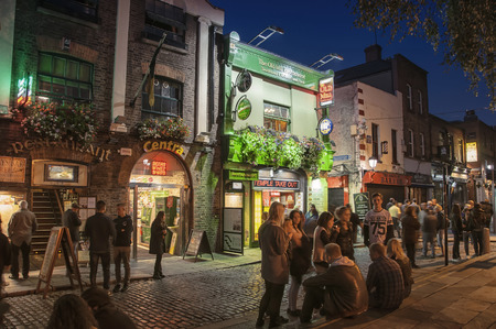DUBLIN, IRELAND - SEPTEMBER 9, 2014: Nightlife at popular historical part of the city - Temple Bar quarter. The area is the location of many bars, pubs and restaurantsのeditorial素材