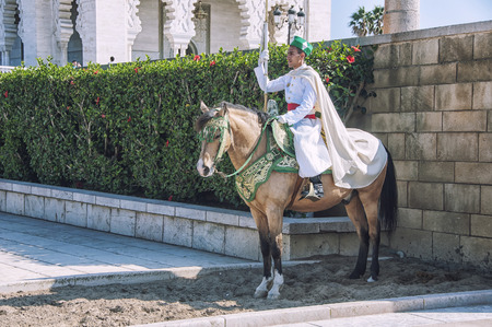RABAT, MOROCCO - MAY 24, 2014: Mounted guards at entrance to Mausoleum complex of Mohammed V - a historical building located on the Yacoub al-Mansour esplanade. Popular touristic landmarkのeditorial素材