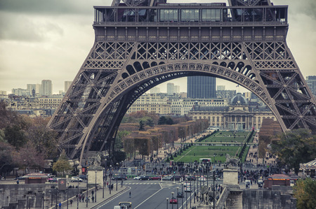 PARIS - NOVEMBER 11, 2014: Close view of famous Eiffel Tower and Champ de Mars with people and cars....