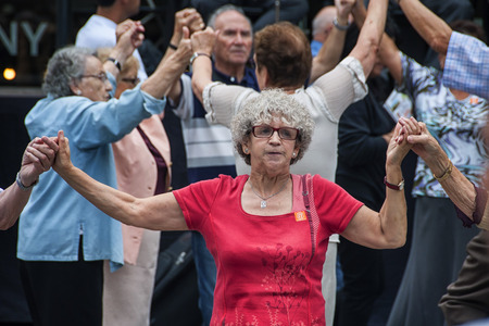 BARCELONA, SPAIN - SEPTEMBER 15, 2013: Close view of people seniors dancing Sardana at Plaza Nova....