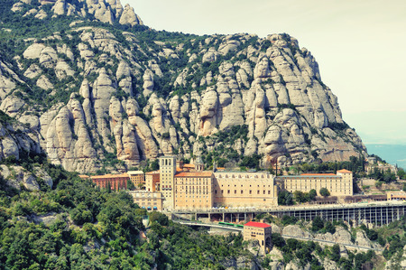 Aerial view of Santa Maria de Montserrat Monastery in Catalonia, Spain with Mountainの写真素材