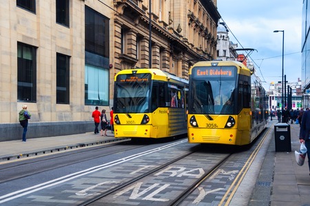 MANCHESTER, UK - SEPTEMBER 3, 2014: Light rail Metrolink tram in the city center. The system has 77 stops along 78.1 km and runs through seven of the ten boroughsのeditorial素材