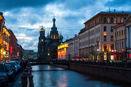 Church on Spilled Blood at night. Saint Petersburg, Russia. Griboyedov canal and a busy street with illuminated buildings. Cloudy blue sky at the backgroundの写真素材