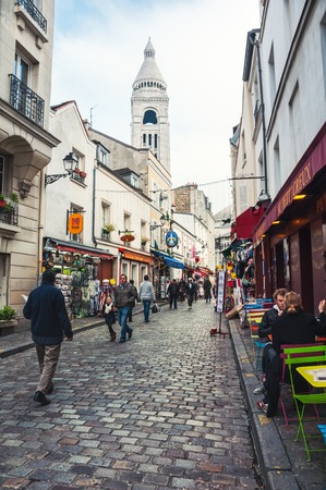PARIS, FRANCE - NOVEMBER 19, 2014: Unidentified people at the streets of Montmartre - a famous place in the city. Restaurants, cafes and different shopsのeditorial素材