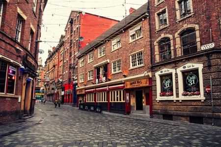 LIVERPOOL, UK - SEPTEMBER 6, 2014: Old red brick buildings in the city center. Restaurants, bars and shops. Vintage streetのeditorial素材