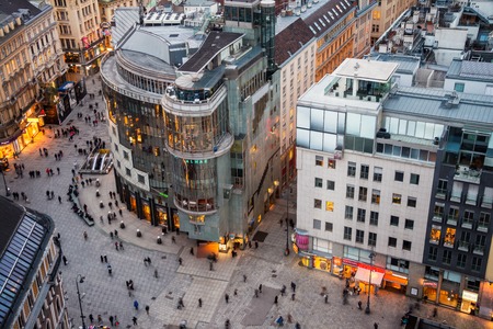 VIENNA, AUSTRIA - FEBRUARY 9, 2016: Crowd of people at the Stephansplatz. Aerial night view of famous landmark with many shops, restaurants, bars and modern buildingsのeditorial素材