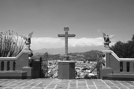 Church of Our Lady of Remedies on top of the Cholula Pyramid in Puebla, Mexico. Aerial view of the city and Popocatepetl volcano. Black and whiteの写真素材