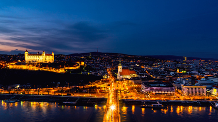 Aerial view of Bratislava, Slovakia at night. Famous castle and illuminated historical buildings with car traffic and riverのeditorial素材
