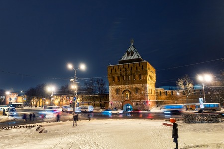 Illuminated Kremlin wall and main gate in Nizhny Novgorod, Russia in winter with white snow...