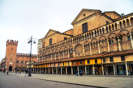 Piazza Trento - Trieste in Ferrara, Italy during the day. People in the city center, cloudy sky and old historical buildingsのeditorial素材