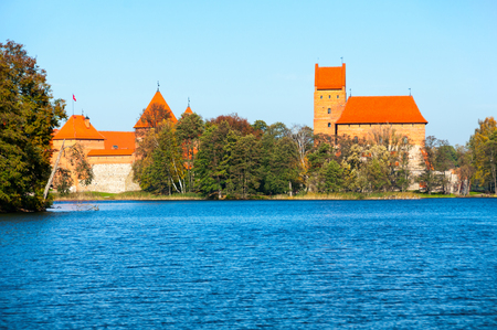 Island castle in Trakai, one of the most popular touristic destinations in Lithuania with trees and blue skyのeditorial素材