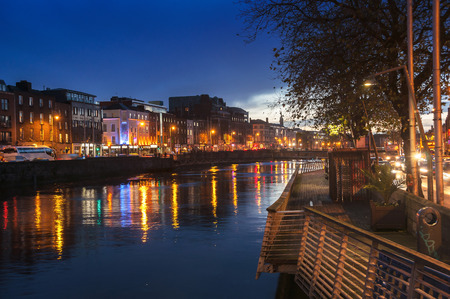 Embankment of Liffey River in Dublin, Ireland. Night view with buildings and city lights at the backgroundのeditorial素材