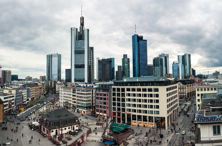 FRANKFURT, GERMANY - MARCH 21, 2014: Famous skyscrapers. Cloudy day in the city center, people and car traffic. Many shops, restaurants and barsのeditorial素材