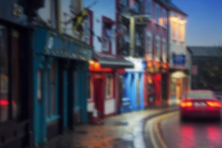 Blurred travel backgrounds - Famous place in Kilkenny, Ireland at night where stand in a row different bars and pubs. It is a popular touristic destinationの写真素材