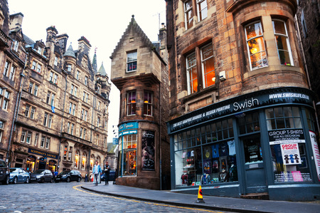 EDINBURGH, SCOTLAND - SEPTEMBER 17, 2014: Famous shops at Cockburn street in Old Town. It is a very historical and touristic street with many cafes and shopsのeditorial素材