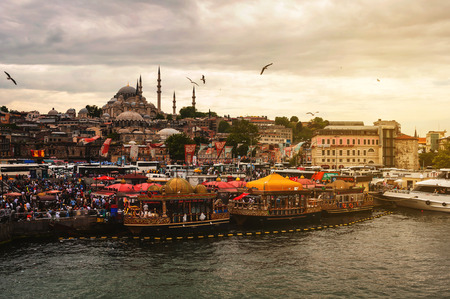 ISTANBUL, TURKEY - MAY 30, 2015: Aerial view of crowded street market at the river Bosphorus with pier, boats and traffic at the background. Suleymaniye Mosque at the backgroundのeditorial素材