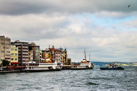 Cruising ship docking on Galata pier on Bosporus, Istanbul, Turkey in cloudy weatherの写真素材