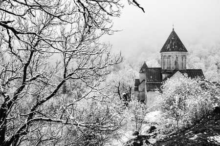 Haghartsin Monastery near small town Dilijan in Armenia. Hidden in winter forest covered with snow. Black and whiteの写真素材