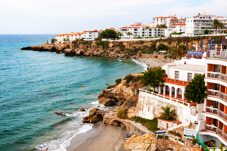 Nerja, Spain. Little touristic town Nerja in Costa del Sol, Andalusia, Spain. It has many restaurants, bars and cafes. Aerial view of the beachの写真素材