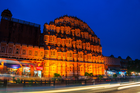Jaipur, India. Illuminated Palace of Winds Hawa Mahal in Jaipur, India at night. Popular touristic landmark, car traffic trails, souvenir shops, dark blue sky. Nightlife in Indiaの写真素材