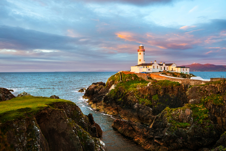Donegal, Ireland. Fanad head at Donegal, Ireland with lighthouse at sunset. Colorful sky, mountains and seaの写真素材