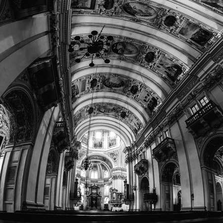 SALZBURG, AUSTRIA - FEBRUARY 19, 2016: Interiors of Baroque Cathedral of Roman Catholic church in Salzburg, Austria. Main altar from the nave. Beautiful decoration. Black and whiteのeditorial素材