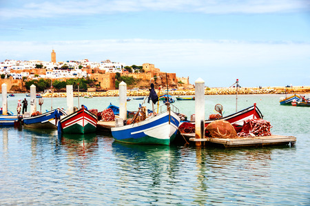 Fishing boats in Rabat, Morocco with old building at the backgroundの写真素材