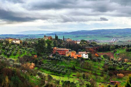 Tuscany, Italy. Landscape Tuscany, Italy with cloudy sky and historical typical buildingの写真素材