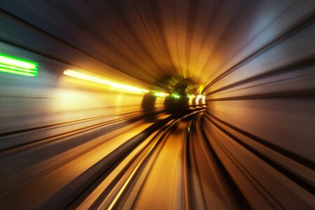 Riding the metro in Copenhagen, Denmark with motion blurred tube lines in tunnel