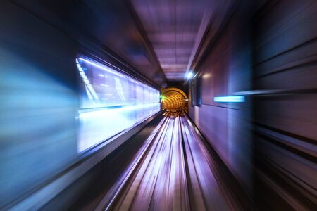 Riding the metro in Copenhagen, Denmark with motion blurred tube lines in tunnelの写真素材