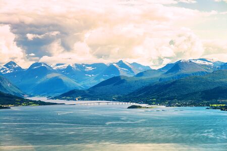 Molde, Norway. Aerial day view of beautiful fjord with snowy mountains in summer in Molde, Norway