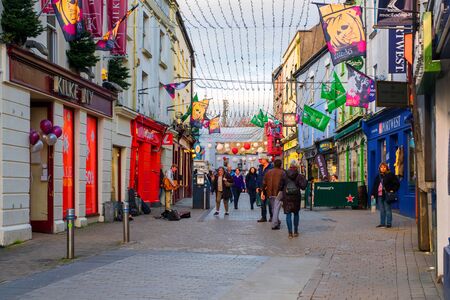 The busy downtown in Galway, Ireland, on a cloudy autumn eveningのeditorial素材