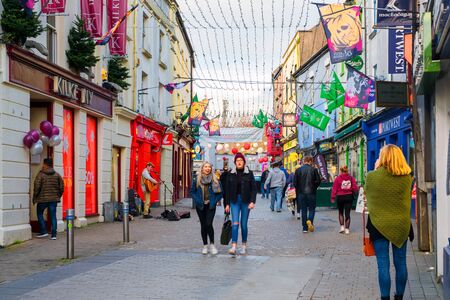 The busy downtown in Galway, Ireland, on a cloudy autumn evening