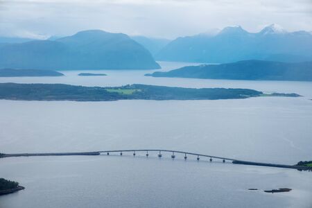Aerial day view of beautiful fjord with snowy mountains in summer in Molde, Norwayの写真素材