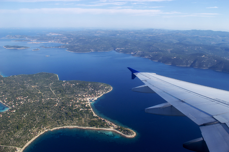 Airplane wing and Croatia land in summertime on a sunny day.の写真素材